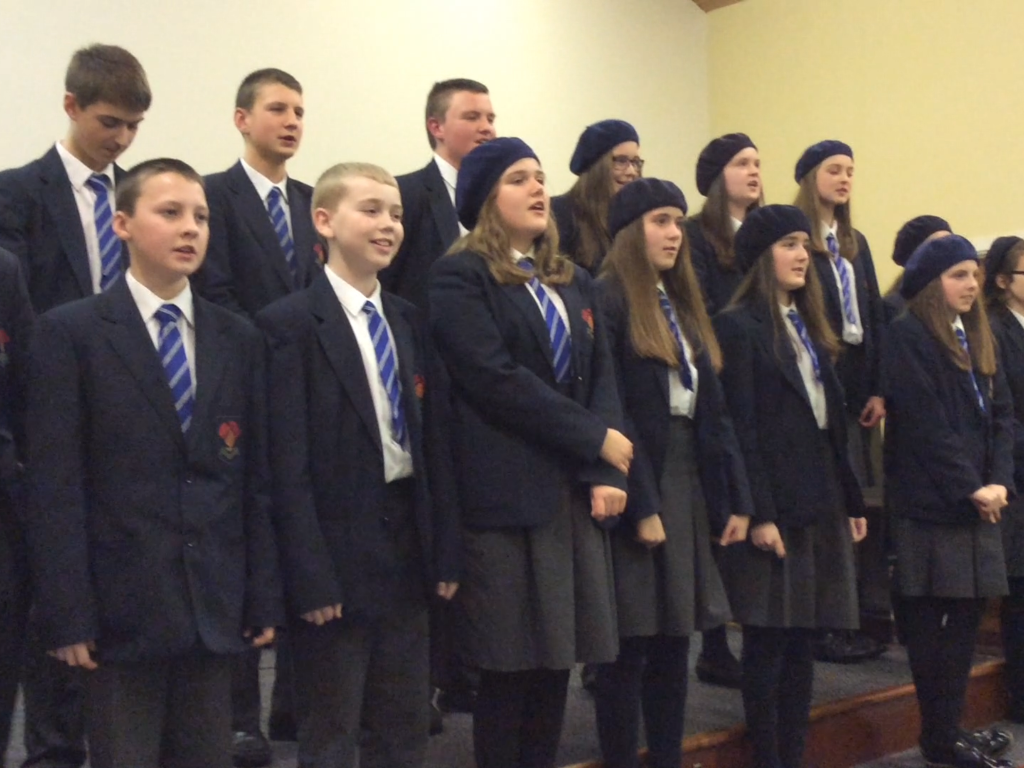 Some of the High School Choir singing, 'Come down and behold the newborn King'